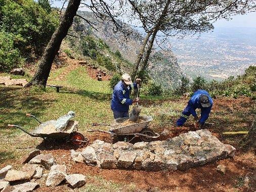 Luke, our caretaker assisting Stephen the builder on one of the benches